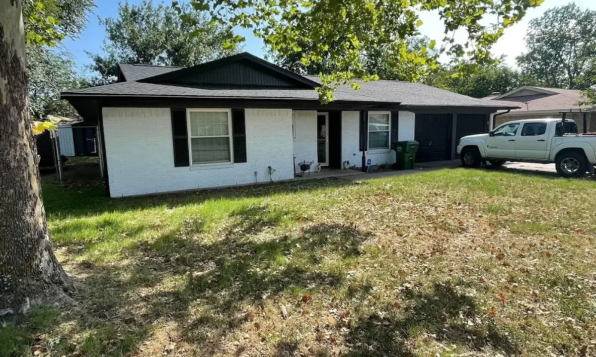 Professional roofing crew working on a residential roof in Estherville